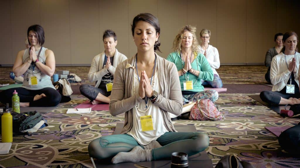 wowen sitting in a yoga class
